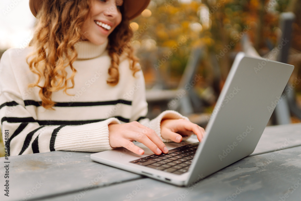 Young woman enjoying a productive outdoor work session at a rustic table near a tranquil waterway in autumn. E-learning concept. Remote work. Young woman enjoying a productive outdoor work session at a rustic table near a tranquil waterway in autumn. E-learning concept. Remote work.