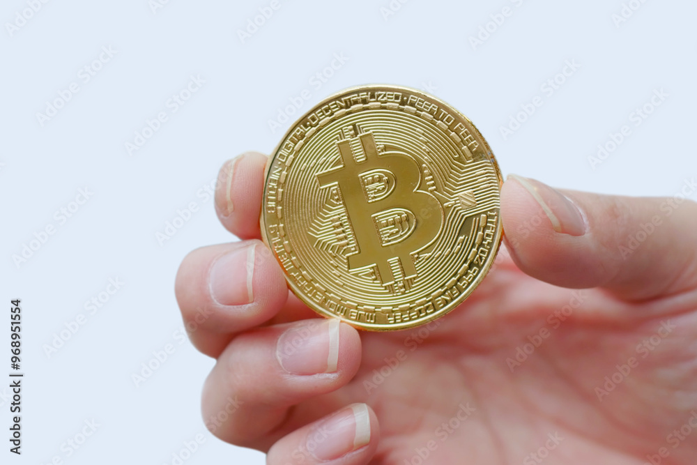 Hand holds bitcoin, metal coin of golden color isolated on white background. Finance design, virtual future currency bitcoin concept. Copy space for advertisement. Advertising area Hand holds bitcoin, metal coin of golden color isolated on white background. Finance design, virtual future currency bitcoin concept. Copy space for advertisement. Advertising area