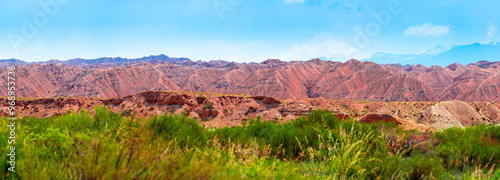 Natural unusual landscape of red rocks against the backdrop of blue mountains. The extraordinary beauty of nature is similar to the Martian landscape. Amazingly beautiful landscape. photo