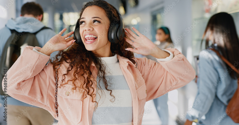 Obraz premium Student, music or excited in university for dance, energy or positive attitude in morning. Girl, headphones or freedom in lobby with tech, media and streaming favorite song on campus for good mood