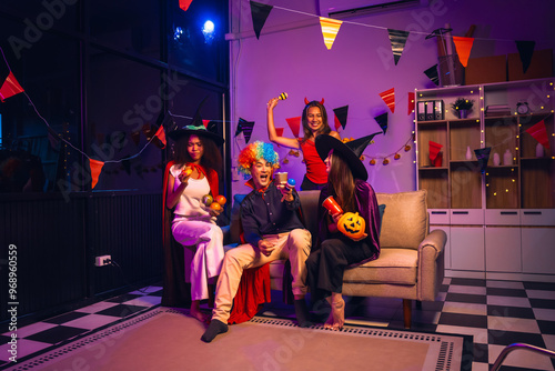 Sticker Asian friends, middle-aged man and young woman, enjoy Halloween office party with vampire costumes, fried chicken, grilled food, grape wine, champagne, RGB lights, festive decorations in the night