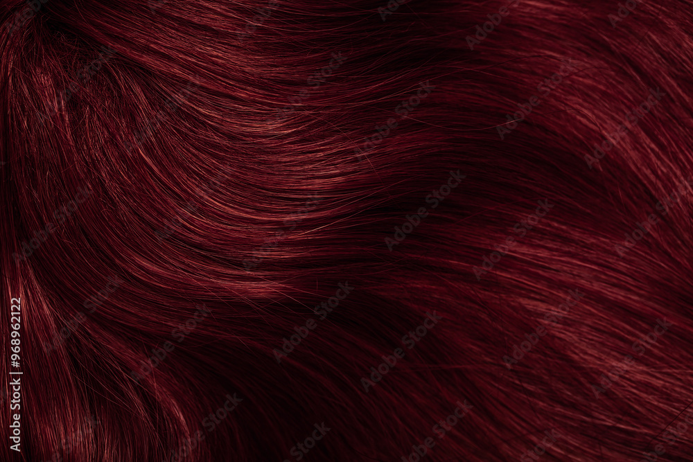 Dark red hair close-up as a background. Women's long brown hair. Beautifully styled wavy shiny curls. Coloring hair with bright shades. Hairdressing procedures, extension. Dark red hair close-up as a background. Women's long brown hair. Beautifully styled wavy shiny curls. Coloring hair with bright shades. Hairdressing procedures, extension.