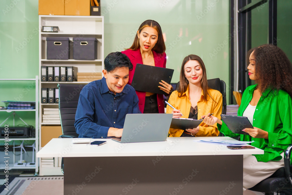 Asian colleagues, middle-aged man and young woman, happily collaborate in office workplace. They gather around laptop, discussing project management, startup plans, teamwork paper stacks on desk. Asian colleagues, middle-aged man and young woman, happily collaborate in office workplace. They gather around laptop, discussing project management, startup plans, teamwork paper stacks on desk.
