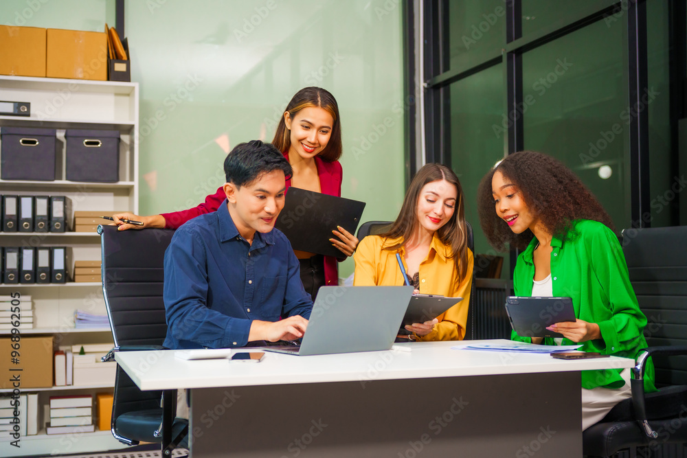 Asian colleagues, middle-aged man and young woman, happily collaborate in office workplace. They gather around laptop, discussing project management, startup plans, teamwork paper stacks on desk. Asian colleagues, middle-aged man and young woman, happily collaborate in office workplace. They gather around laptop, discussing project management, startup plans, teamwork paper stacks on desk.