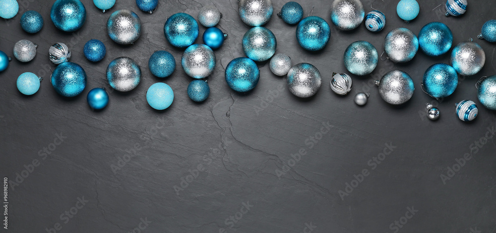Different Christmas balls on grey textured background, flat lay. Space for text
