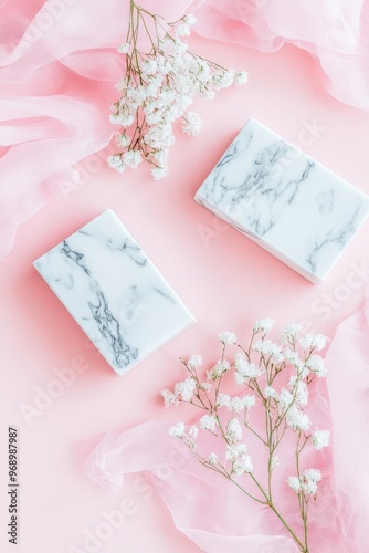 Display set with a pastel pink and white stone marble background decorated with white flowers
