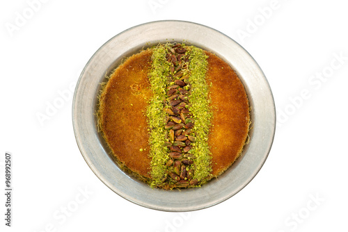 Traditional classic katmer served on a metal plate with lots of pistachios on top. top view, white background. photo