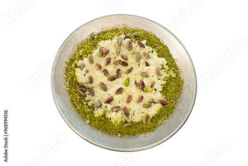 Raw katmer with clotted cream and pistachios served on a metal plate with lots of pistachios on top. top view, white background. photo