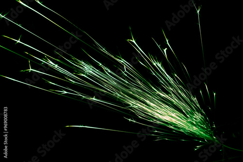green sparks from the grinder glowing in the dark