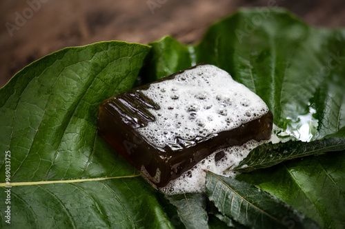 Glycerin soap mixed with neem purple leaves extract and honey on natural background. photo