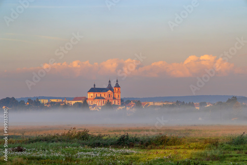 church shrouded in fog in Dobrany, Czech republic photo