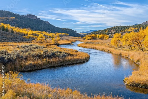 Tranquil river winding through autumn valley surrounded by golden trees and blue sky, Ai Generation