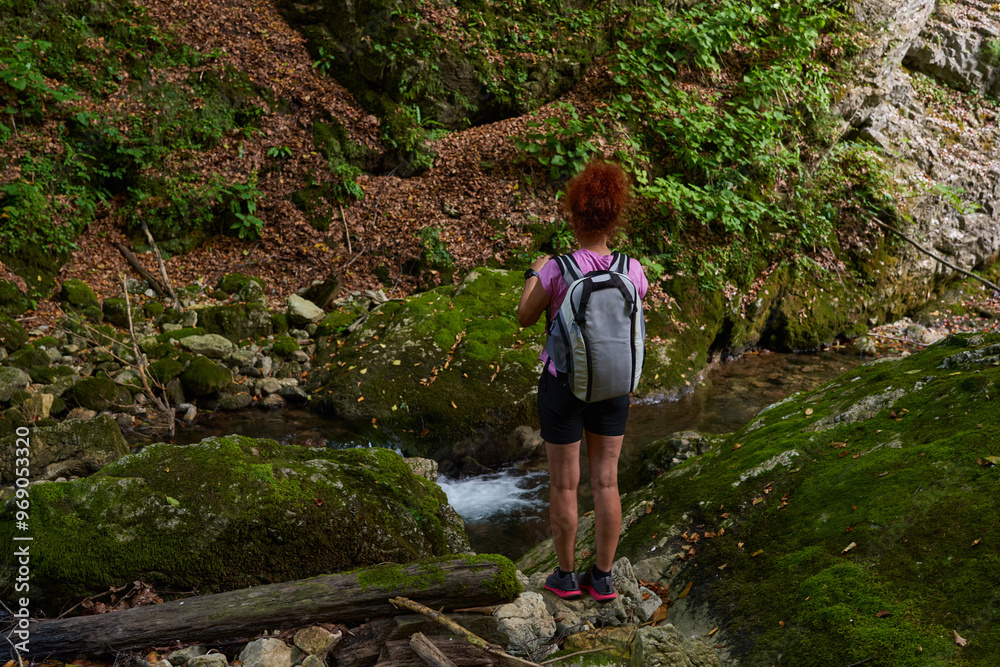 Woman hiker by the river Woman hiker by the river