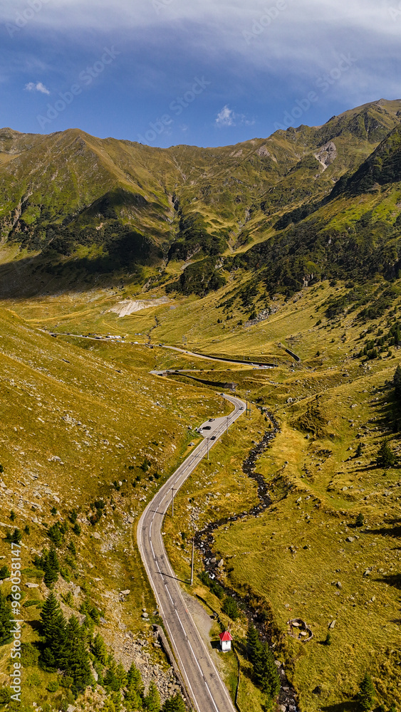 Top cinematic aerial view to the Transfagaras famous curvy road in Romania. Aerial view of Transfagarasan road in Fagarash Mountain.