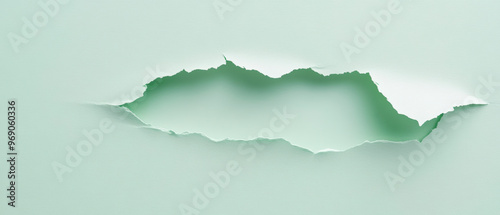 A torn or ripped pale green paper, reveals a darker green layer underneath. The tear creates an irregular, mountain-like silhouette across the centre of the image. Generative AI