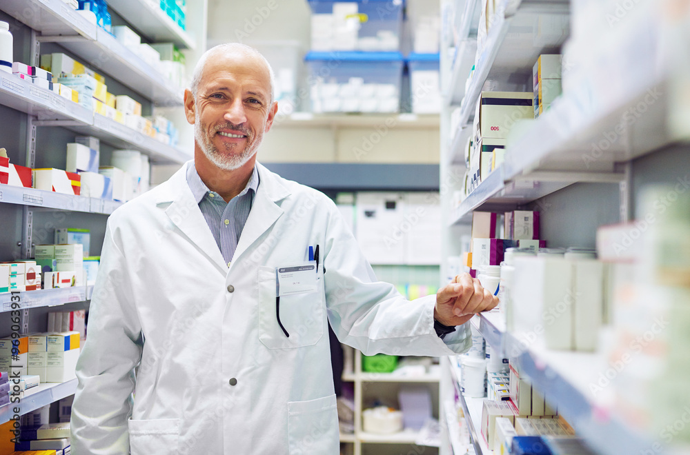 Mature man, pharmacy portrait and inventory check at store, manager and confident chemist. Shop, dispensary and proud of medication treatment at apothecary, expert service and stock shelf in England Mature man, pharmacy portrait and inventory check at store, manager and confident chemist. Shop, dispensary and proud of medication treatment at apothecary, expert service and stock shelf in England
