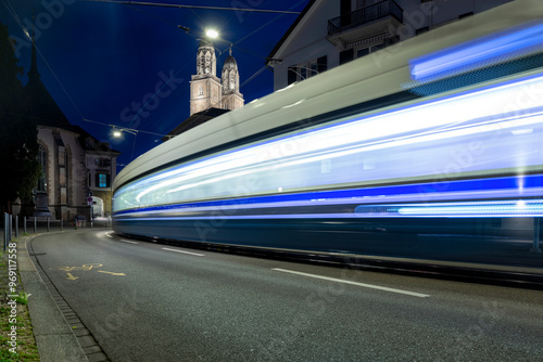 City tram in motion passing the turn at night