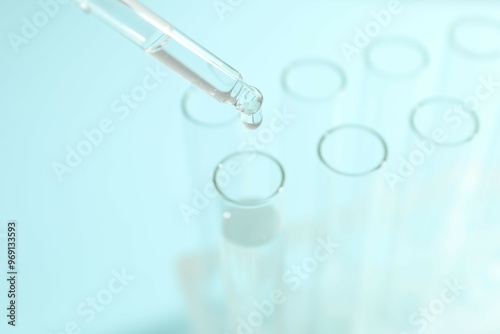 Laboratory test tubes with pipette on colored background