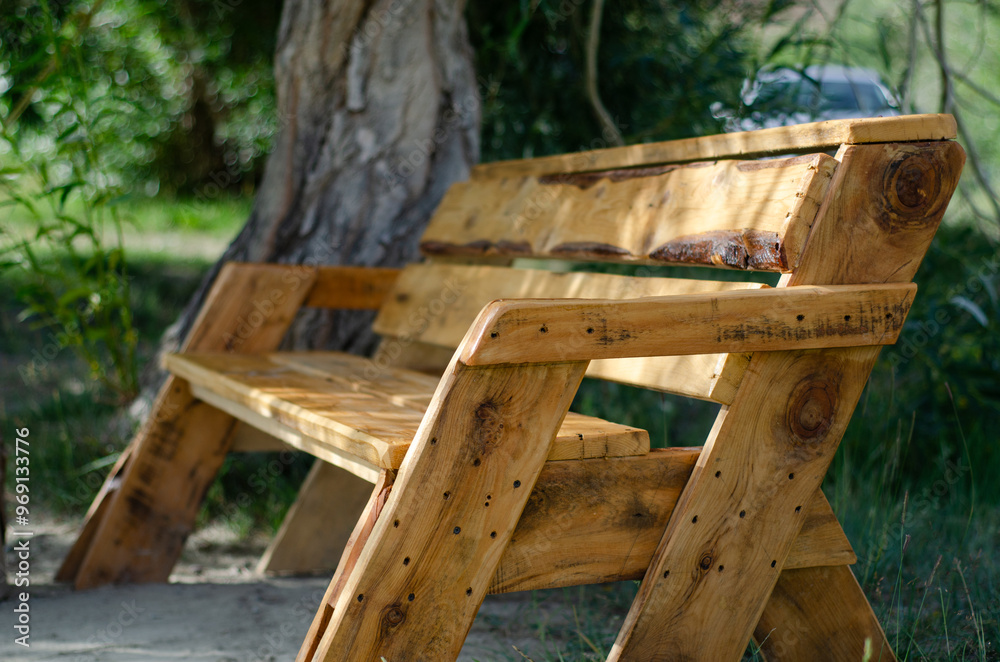 Naklejka premium Wooden bench in a garden park on a sunny afternoon. Relax place. Nature tourism. object wooden