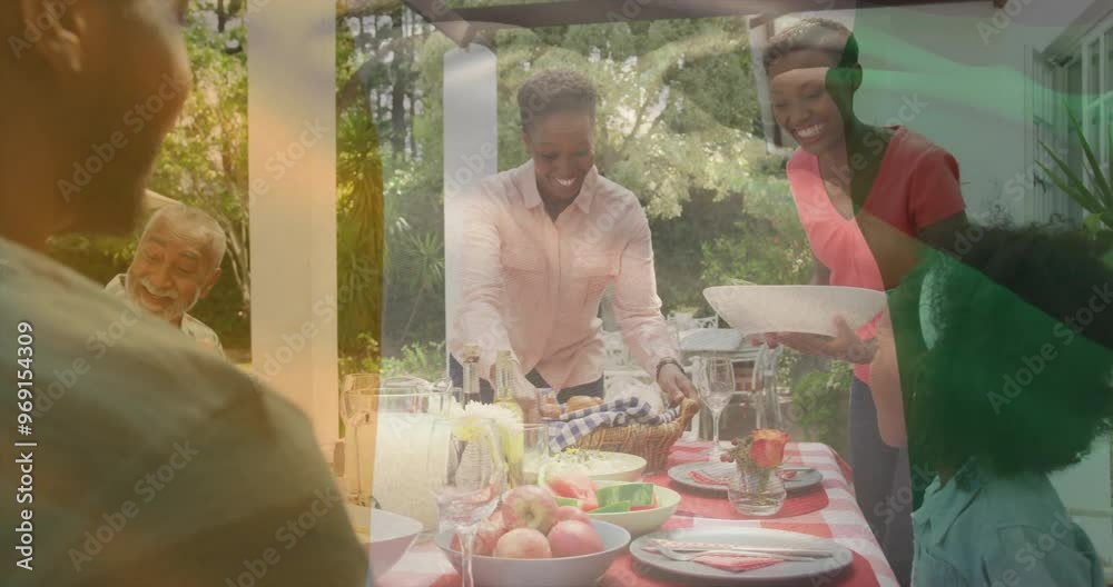 Animation of flag of ivory coast over african american family eating dinner together