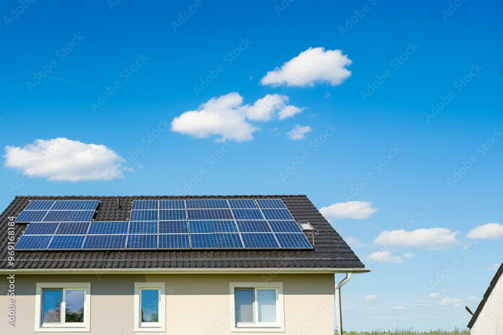 Solar Panels on House Roof. Sustainable Renewable Energy. Sunny weather with blue and few clouds. Solar Panels on House Roof. Sustainable Renewable Energy. Sunny weather with blue and few clouds.