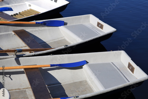 Boats with oars floating on the water, serene atmosphere