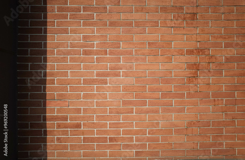 Obraz na płótnie Red brick wall summer background with shadows. Brick wall copy space background. w salonie