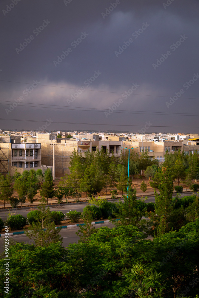 Obraz premium Dark clouds over a city just before the rain in Yazd, Iran. 