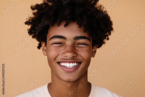 Happy young African American gen z guy winking isolated on beige background. Playful ethnic teen student, cool curly generation z teenager smiling with white perfect teeth, with generative ai