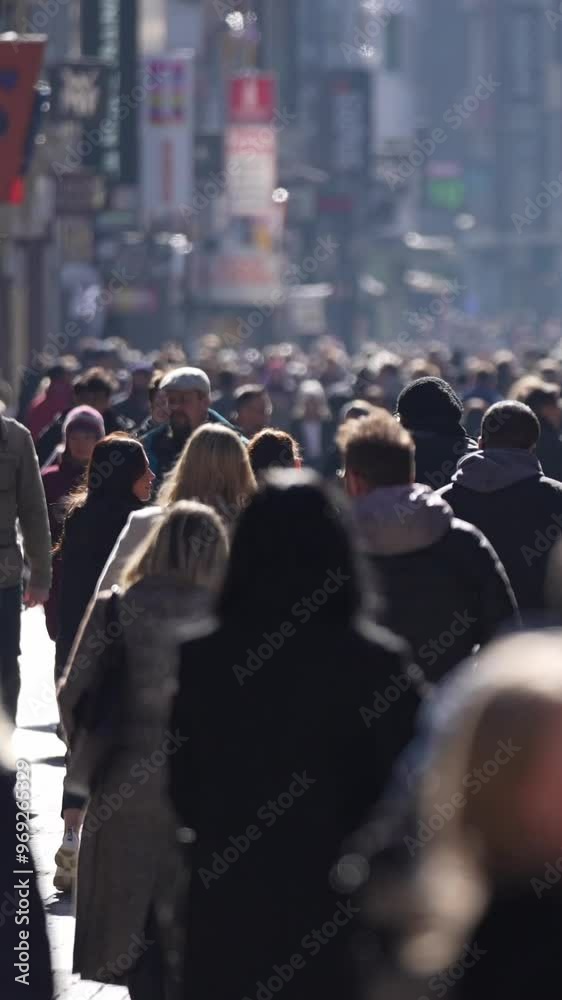 time lapse of dense crowd of people walking in European High street, backlit scene