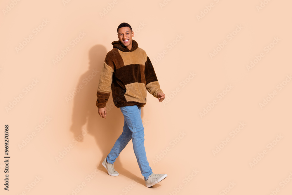 Fototapeta premium Photo of good mood funny nice man wear stylish clothes walk empty space isolated on beige color background