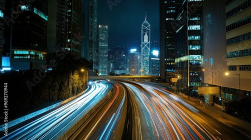 Nighttime cityscape with light trails and skyscrapers.