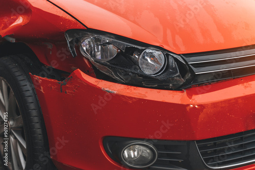 Damaged Orange Car in a Parking Lot Shows Its Distressed Fender and Headlight