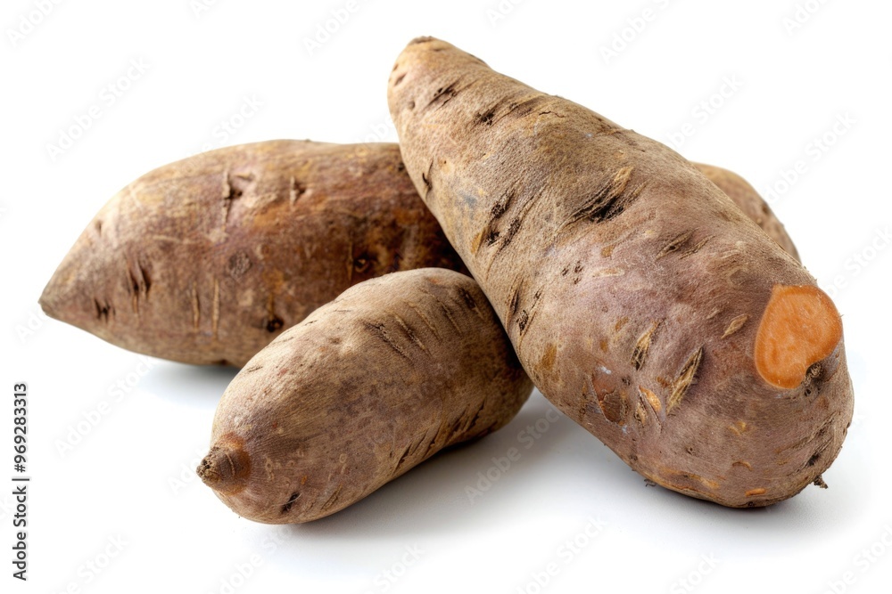 Freshly harvested sweet potatoes arranged on a clean white surface, perfect for food photography or styling Freshly harvested sweet potatoes arranged on a clean white surface, perfect for food photography or styling