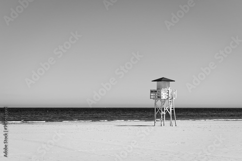 Black and white beach landscape of a deserted beach with a guardhouse photo