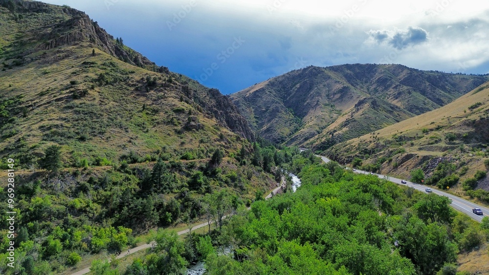 Aerial view of a lush valley with a winding river and road. Aerial view of a lush valley with a winding river and road.