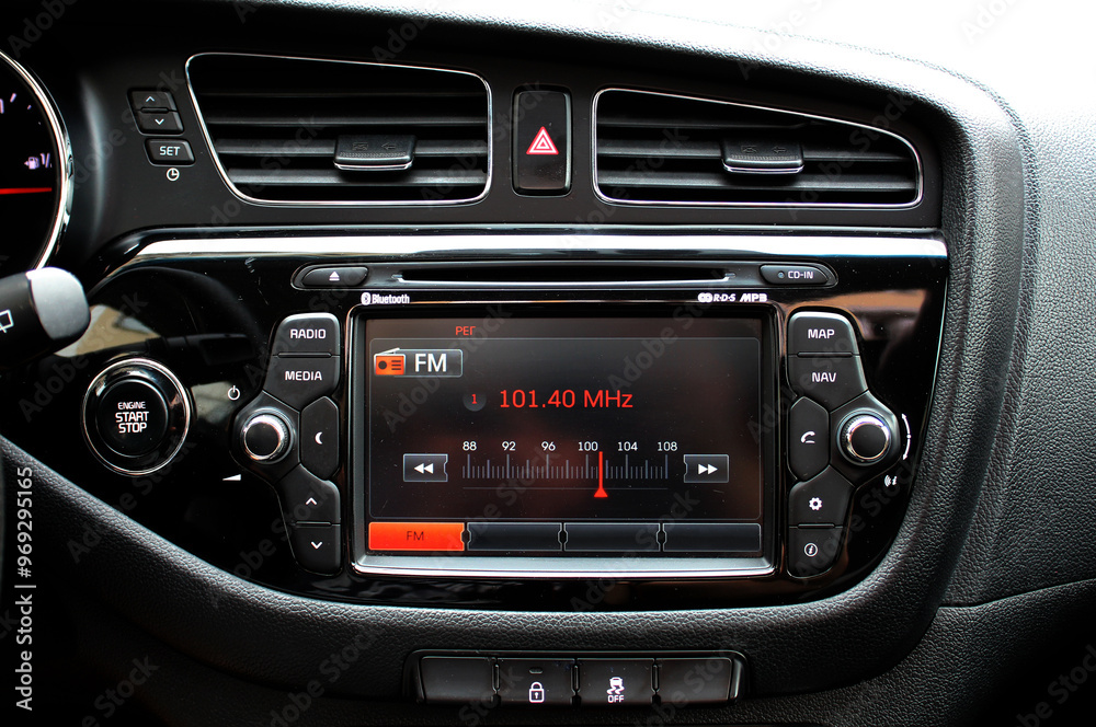 Monitor on dashboard of car in FM receiver. Controlling volume in car. Modern car multimedia. Detail of the car interior. Monitor on dashboard of car in FM receiver. Controlling volume in car. Modern car multimedia. Detail of the car interior.