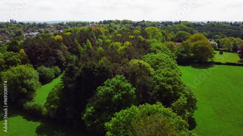 Wadhurst Town's lush, green landscape with rural houses on a sunny day with cloudy sky in England photo