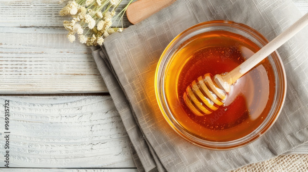 Fototapeta premium a bowl with honey and a wooden spoon