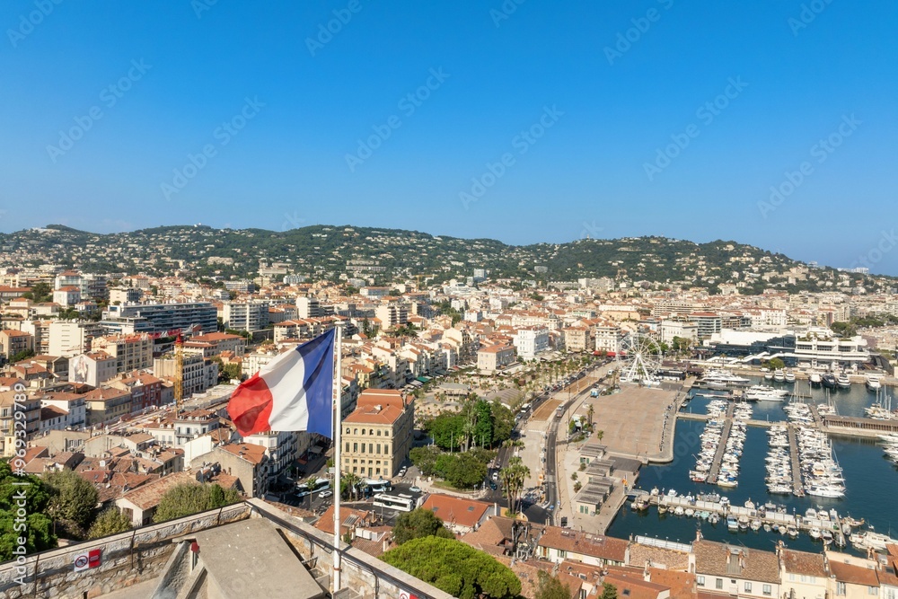 Aerial view of Cannes with French flag and marina Aerial view of Cannes with French flag and marina