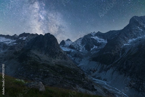 Landscape view of the milky way above a Swiss mountain range and a glacier's valley photo