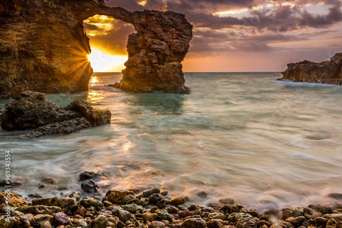 Pebbles beach with an arch in Cabo Rojo at sunset, located at the southwestern point of Puerto Rico photo