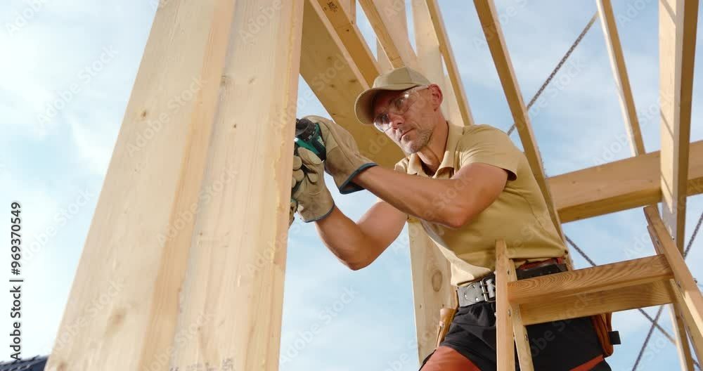 Construction Worker Uses Power Drill to Assemble Wooden Framework in ...