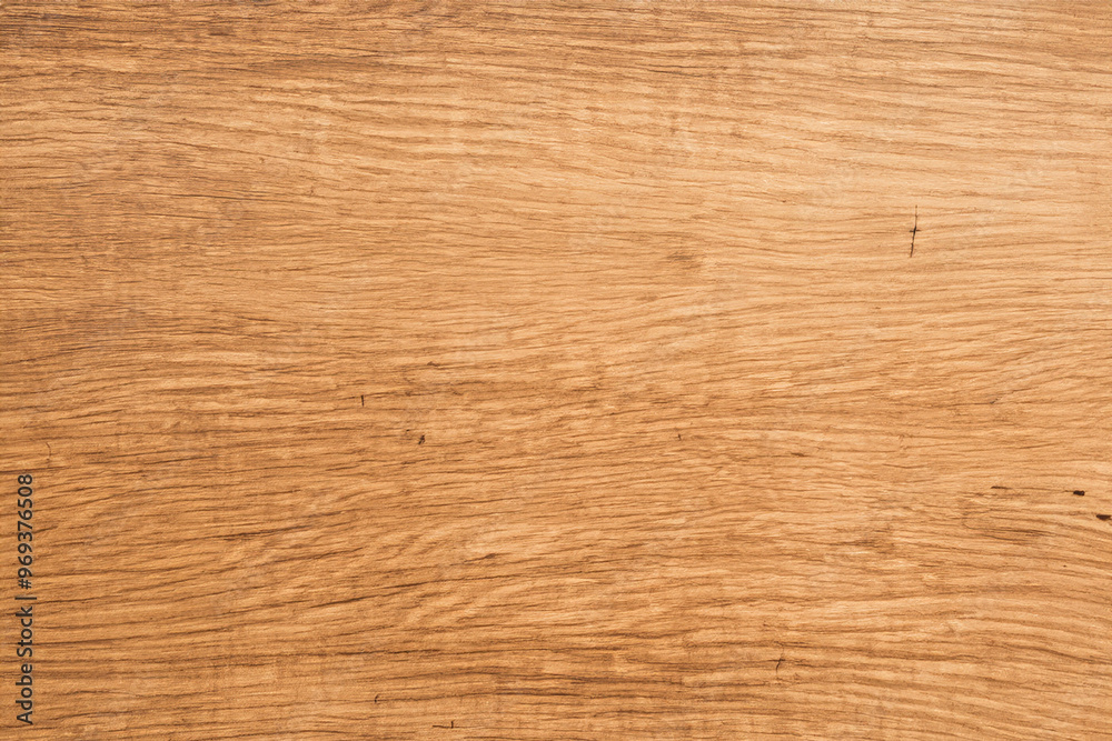 Close-up of a light brown wooden texture with grain patterns.