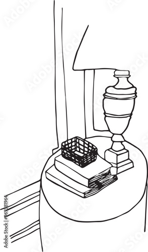 Table ronde d'appoint placée près d'un mur avec livres, boîte et lampe. Esquisse minimaliste noir sur fond blanc