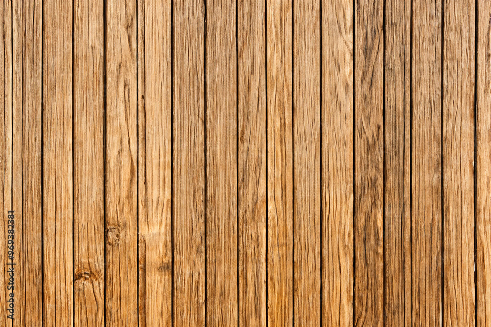 Closeup of a rustic wooden wall made from multiple vertical brown planks. Closeup of a rustic wooden wall made from multiple vertical brown planks.