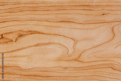 Close-up of natural light wood grain texture with a subtle swirl pattern.