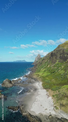 rocky steep shoreline by the ocean at the beach of Whangarei Heads in the North Island, New Zealand photo