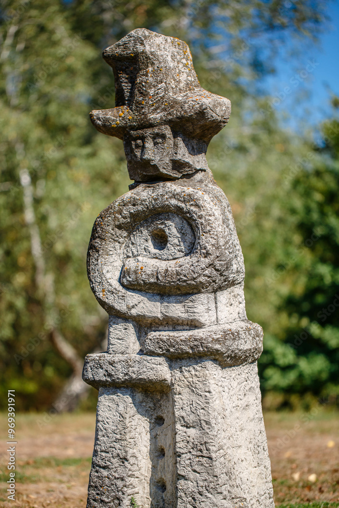 The figure of the ancient gods on the stones in the autumn park. Ukraine. Scythian culture