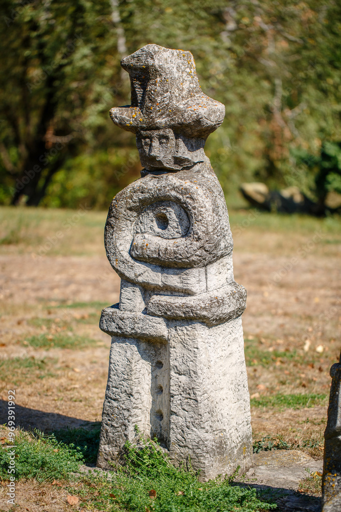 The figure of the ancient gods on the stones in the autumn park. Ukraine. Scythian culture